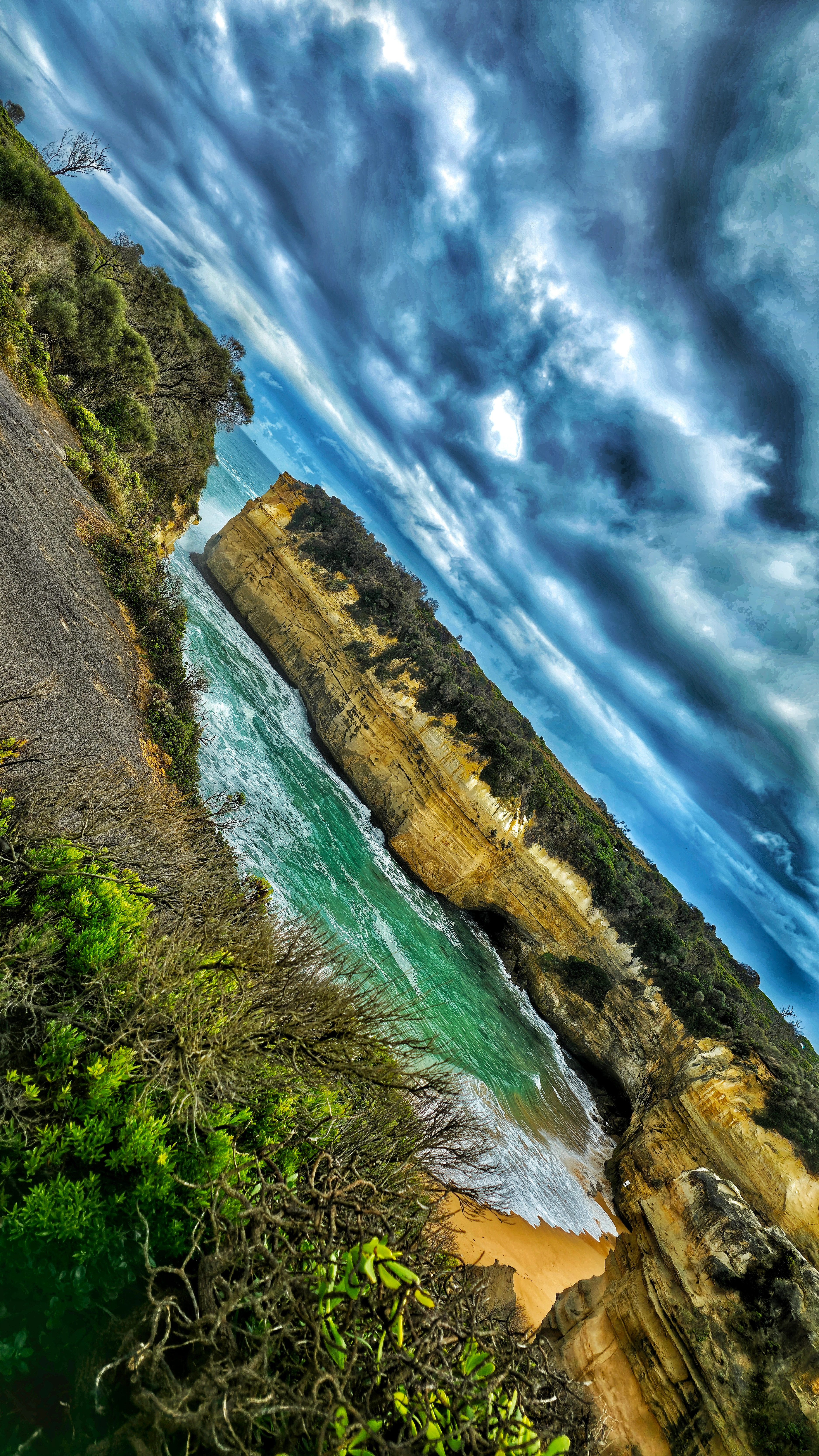 Young man in red and white varsity jacket posing in underground parking garage